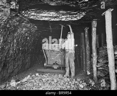 Vintage photo circa 1923 of a miner at work in an unidentified coal mine in the USA. Stock Photo