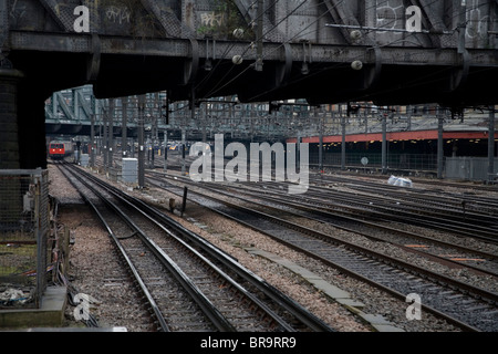 Tube train approaching Westbourne Park Station on tracks under bridge ...