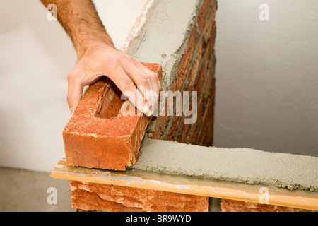 hand of bricklayer by the work Stock Photo