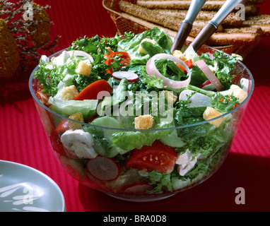 TOSSED LETTUCE SALAD IN A CLEAR GLASS BOWL Stock Photo