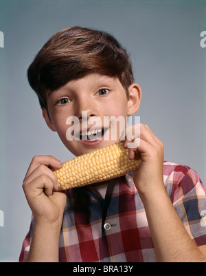 1960s SMILING BOY EATING CORN ON THE COB Stock Photo