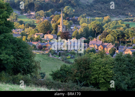 Ashover village Derbyshire and the spire of All Saints parish church in evening light Stock Photo