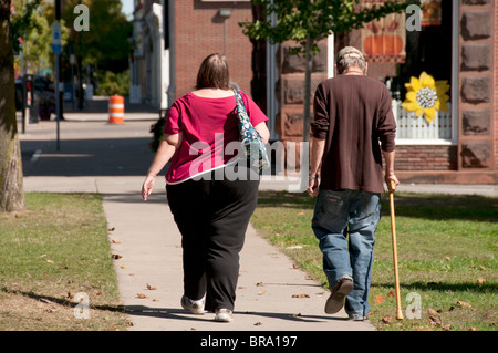 Contrasting couple walking. Stock Photo