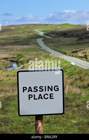 Passing Place sign by single track road overlooking a loch in the Outer ...