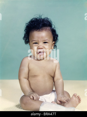 1960s PORTRAIT AFRICAN-AMERICAN BABY BOY WEARING DIAPER SMILING MAKING FACIAL EXPRESSION Stock Photo