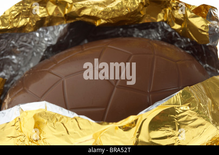 gold foil wrapped easter egg opened Stock Photo