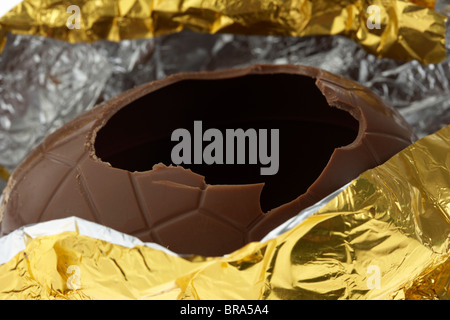 gold foil wrapped easter egg opened and cracked Stock Photo