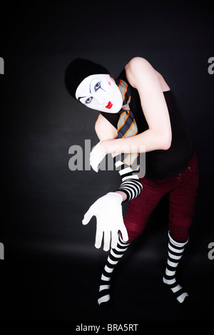 Funny mime in white gloves on black background Stock Photo