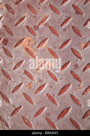 background texture of a red steel metal grate with patterned ridges Stock Photo