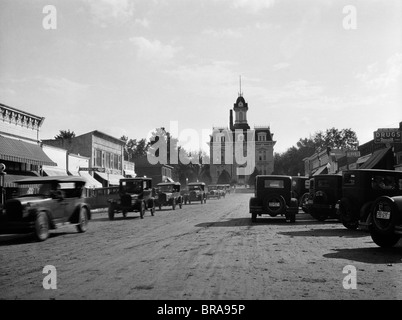 1920s 1928 VIEW OF COTTONWOOD FALLS KANSAS MAIN STREET WITH TRAFFIC Stock Photo