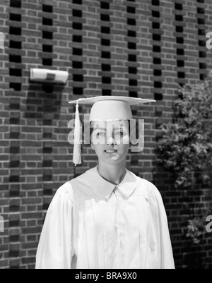 1960s PORTRAIT TEEN GIRL WHITE CAP AND GOWN GRADUATION ROBE Stock Photo