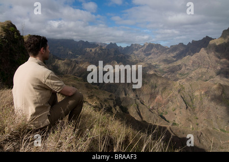 Man looking out over rocky landscape on island of San Antao, Cape Verde Islands, Africa Stock Photo