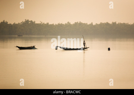 A man stands on a boat in the Sunderbans (Sundarbans) National Park, UNESCO World Heritage Site, West Bengal, India, Asia Stock Photo