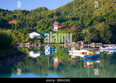 The harbour and church, Baie Sainte Anne, Baie Sainte Anne district, Island of Praslin, Seychelles, Indian Ocean, Africa Stock Photo