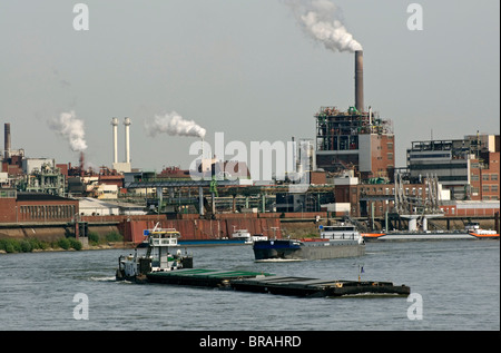 Boat traffic on the Rhine with Chempark Krefeld in background, NRW, Germany. Stock Photo