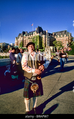 Local Scotish bag pipe player in front of the famous Empress Hotel in beautiful Victoria British Columbia Canada Stock Photo