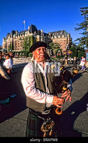 Local Scotish bag pipe player in front of the famous Empress Hotel in beautiful Victoria British Columbia Canada Stock Photo