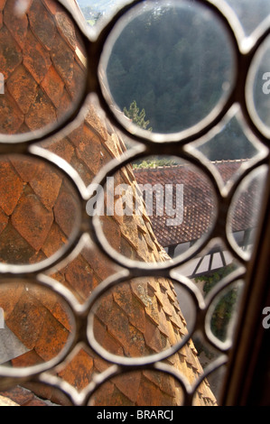 Romania, Transylvania, Bran Castle National Monument (aka Dracula's Castle), c. 1377. Roof view through medieval glass window. Stock Photo