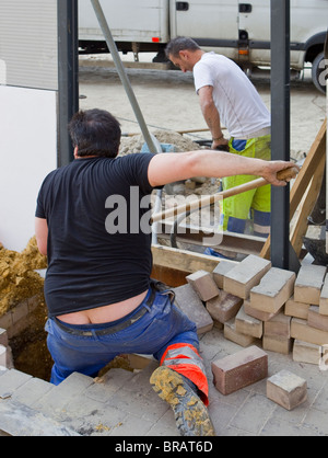 Portrait of two builders works at construction site Stock Photo - Alamy