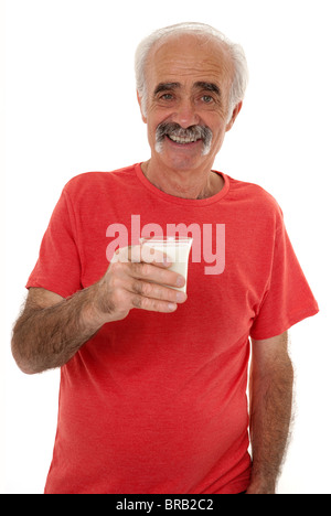 Senior holding a glass of milk Stock Photo