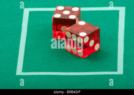 Pair of dice on green casino table felt, 7 rolled Stock Photo