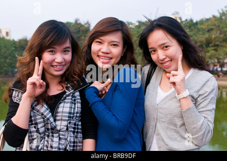 Three happy young women smiling for the camera, Hanoi, Vietnam, Indochina, Southeast Asia, Asia Stock Photo