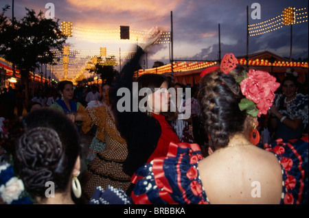 Spain Andalucia Seville Female Flamenco Dancers Dancing in Street At Sunset In Traditional Costume During The April Fair Stock Photo