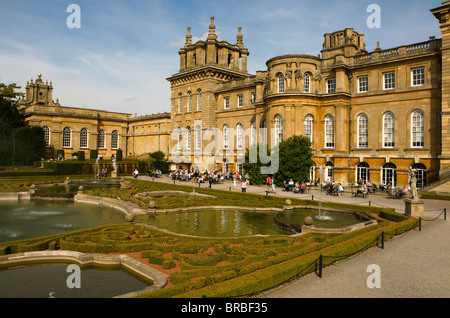 Tourists enjoying the sunshine in the formal gardens at Blenheim Palace, Oxfordshire. Stock Photo