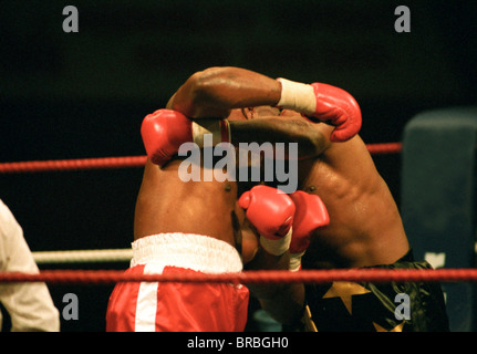 Two boxers exchange punches in ring Stock Photo