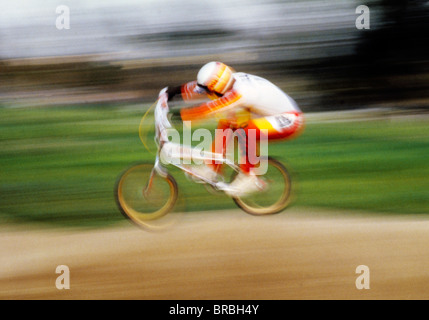 Young man performing a stunt on a bike Stock Photo