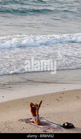 Man doing yoga on Jaffa beach, Jaffa, Israel Stock Photo