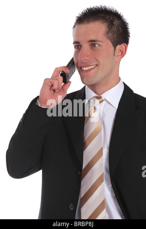 A handsome businessman gets a pleasant call. All on white background. Stock Photo