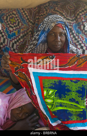 Woman selling colourful tablecloth at the tent market of Nouakchott, Mauritania Stock Photo