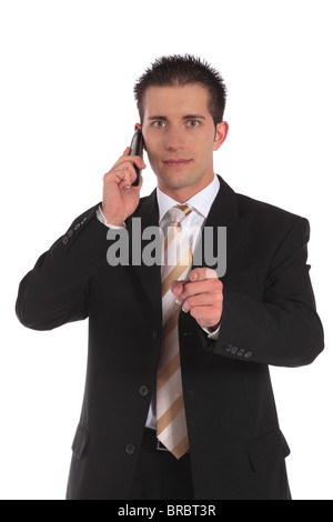 A businessman making a serious phone call and pointing with finger. All on white background. Stock Photo