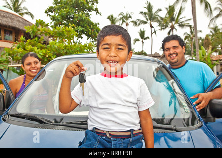 young mexican family with car Stock Photo