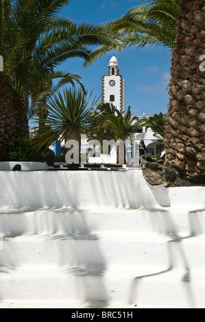 dh  SAN BARTOLOME LANZAROTE People clock tower white building and village plaza square palm trees Stock Photo