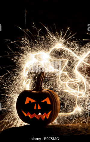 Halloween pumpkin, Jack o lantern, fire face and fireworks Stock Photo