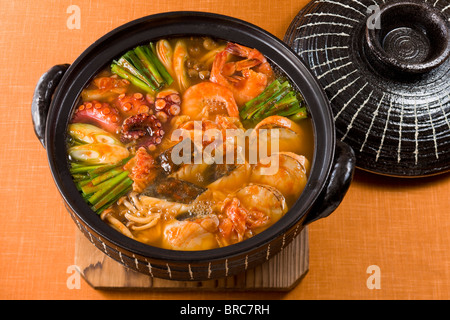 Korean signature Kimchi Stew in a hot ceramic pot served with other side  dishes Stock Photo - Alamy