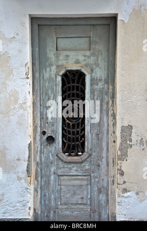 Weathered derelict house wooden door. Vintage metalwork pattern. Stock Photo