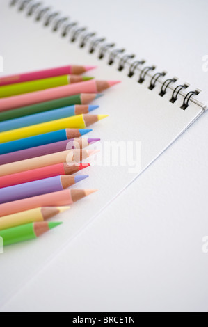 Colored pencils and notebook Stock Photo
