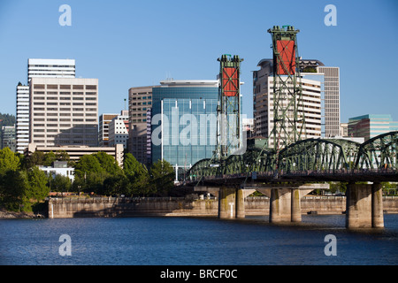 Portland Oregon skyline with Hawthorne bridge crossing the Willamette river under clear blue sky Stock Photo