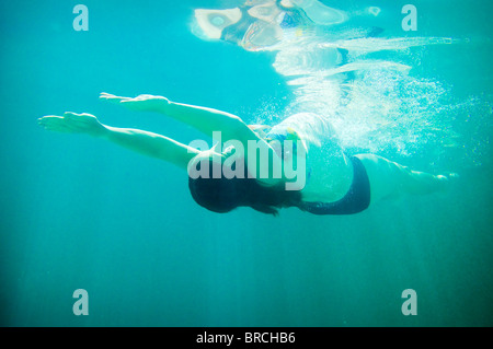 Pregnant woman underwater in swimming pool Stock Photo