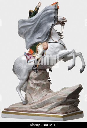 Emperor Napoleon I (1769 - 1821) - a coloured porcelain figure., With bicorne and coat on a rearing white horse, his right hand pointing ahead. Inspired by J.L. David's painting 'Napoleon Crossing the Alps at the Saint-Bernard Pass'. Colour-glazed porcelain, the base with the maker's mark Sitzendorf A. Voigt AG / VEB Sitzendorfer Porcelain Manufactory, made after 1954. Firing flaw in the base. Height 41 cm. people, 1950s, 20th century, France, Imperial, French Empire, object, objects, stills, clipping, cut out, cut-out, cut-outs, man, men, male, Stock Photo