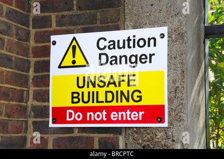 Danger! This building is unsafe. Do not enter. Sign on a building in ...