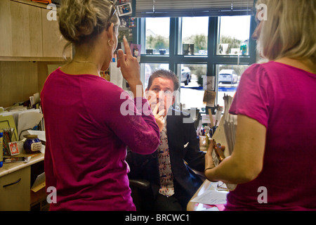 A concerned Southern California school principal meets with two women teachers in his office. Stock Photo