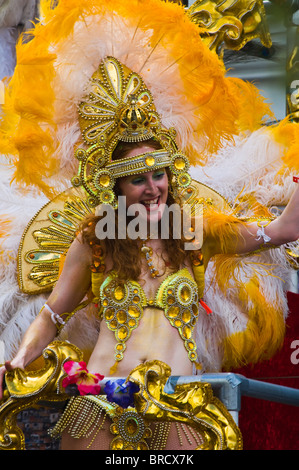 A colourful and costumed female street performer aboard a float at the 2009 Notting Hill Carnival Stock Photo