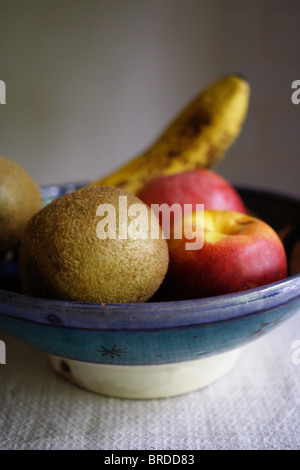 A bowl of fruit: nectarine, apple, banana and kiwi Stock Photo