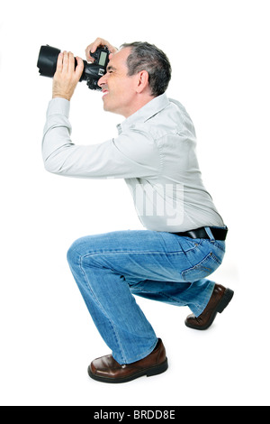 Portrait of male photographer with camera isolated on white background Stock Photo