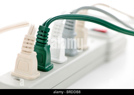Many plugs plugged into electric power bar Stock Photo