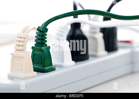 Many plugs plugged into electric power bar Stock Photo
